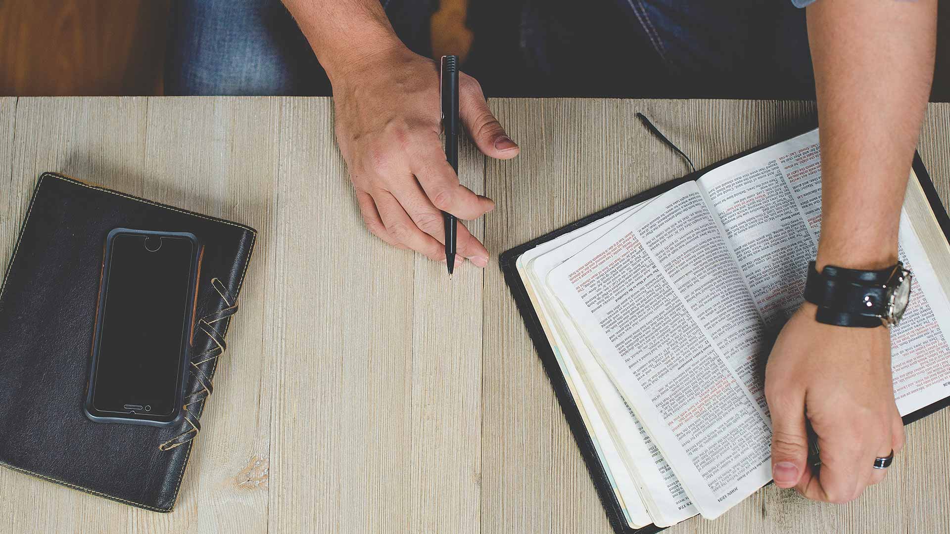 Open bible with phone